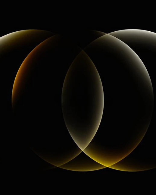 Three glowing rings overlapping on black, lit in gold and amber